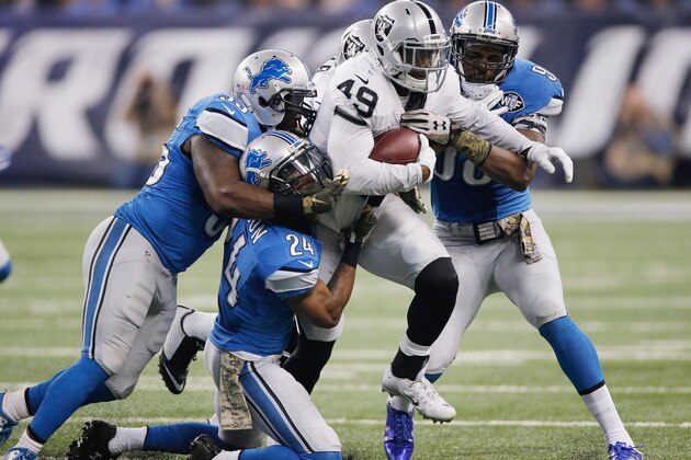 DETROIT, MI - NOVEMBER 22: Jamize Olawale #49 of the Oakland Raiders tries to break the tackle by the Detroit Lions in the second quarter at Ford Field on November 22, 2015 in Detroit, Michigan. (Photo by Gregory Shamus/Getty Images)