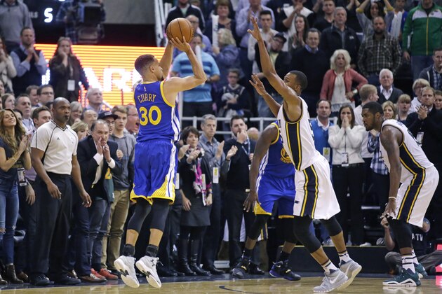 Golden State Warriors guard Stephen Curry (30) hits a 3-pointer against Utah Jazz guard Rodney Hood (5) in the second half during an NBA basketball game Monday, Nov. 30, 2015, in Salt Lake City. Warriors won 106-103. (AP Photo/Rick Bowmer)