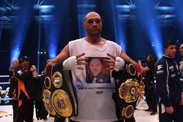 British Tyson Fury celebrates after the WBA, IBF, WBO and IBO title bout against Ukrainian world heavyweight boxing champion Wladimir Klitschko in Duesseldorf, western Germany, on November 28, 2015. Fury won the fight after 12 Rounds of Boxing. AFP PHOTO / PATRIK STOLLARZ / AFP / PATRIK STOLLARZ        (Photo credit should read PATRIK STOLLARZ/AFP/Getty Images)