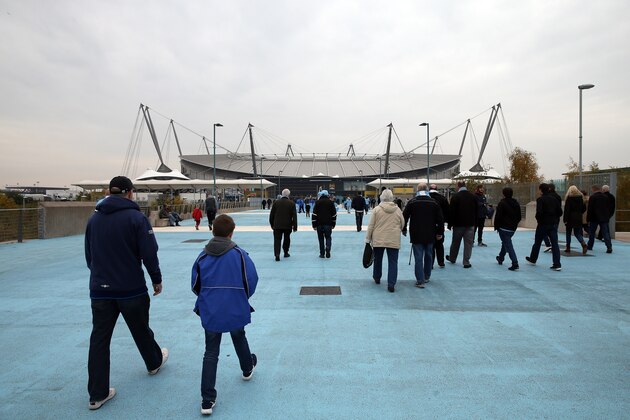 MANCHESTER, ENGLAND - OCTOBER 31: Fans make their way to the stadium ahead of the stadium ahead of the Barclays Premier League match between Manchester City and Norwich City at Etihad Stadium on October 31, 2015 in Manchester, England. (Photo by Chris Brunskill/Getty Images)
