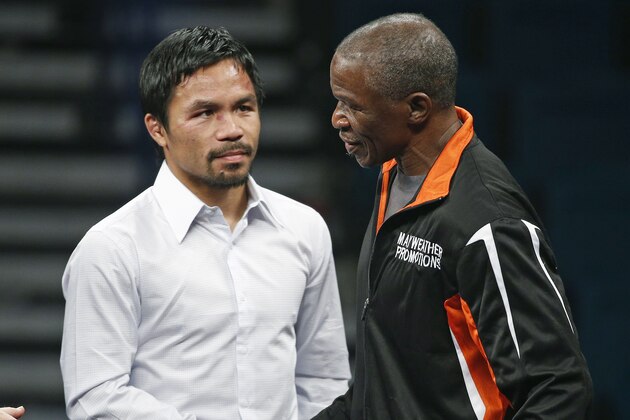 Manny Pacquiao, left, shakes hands with Floyd Mayweather Sr. during a press conference following their welterweight title fight on Saturday, May 2, 2015 in Las Vegas. Mayweather defeated Pacquiao in a unanimous decision. (AP Photo/John Locher)