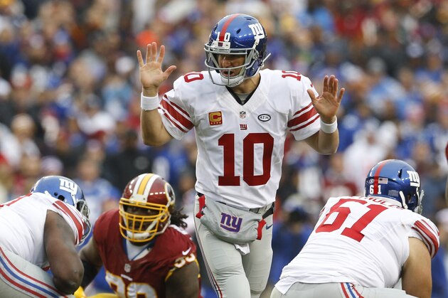 New York Giants quarterback Eli Manning (10) signals to the back field during the first half of an NFL football game against the Washington Redskins in Landover, Md., Sunday, Nov. 29, 2015. (AP Photo/Patrick Semansky)