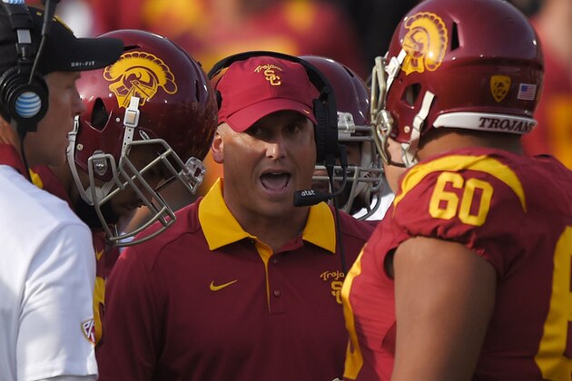 Southern California interim head coach Clay Helton talks to his team during the first half of an NCAA college football game against Utah, Saturday, Oct. 24, 2015, in Los Angeles. (AP Photo/Mark J. Terrill)