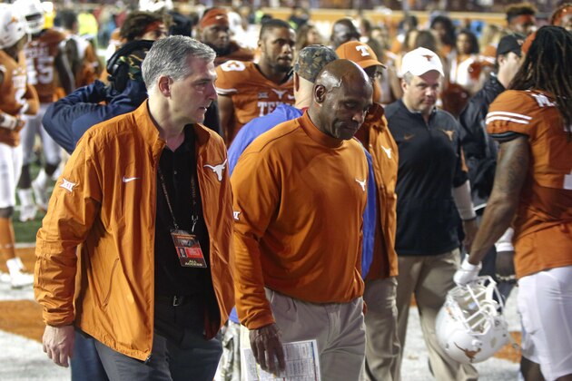 Texas coach Charlie Strong, center, walks off the field after Texas Tech defeated Texas 48-45 in an NCAA college football game Thursday, Nov. 26, 2015, in Austin, Texas. (AP Photo/Michael Thomas)