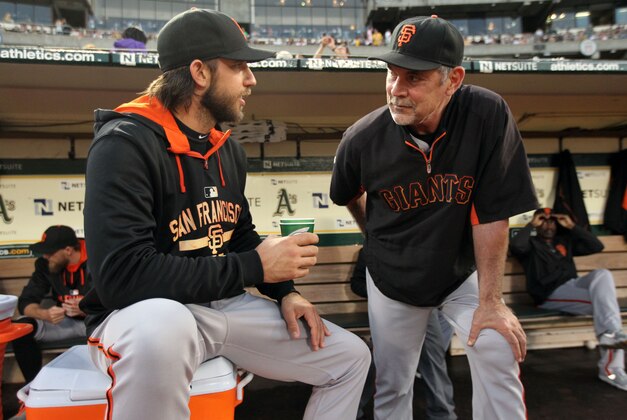 Sep 25, 2015; Oakland, CA, USA; San Francisco Giants pitcher Madison Bumgarner (40) talks with manager Bruce Bochy (15) prior to the start of their MLB baseball game with the Oakland Athletics at O.co Coliseum. Mandatory Credit: Lance Iversen-USA TODAY Sports