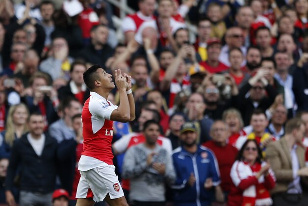 Arsenal's Alexis Sanchez celebrates after scoring the opening goal of the game during the English Premier League soccer match between Arsenal and Manchester United at Emirates stadium in London, Sunday, Oct. 4, 2015.(AP Photo/Frank Augstein)