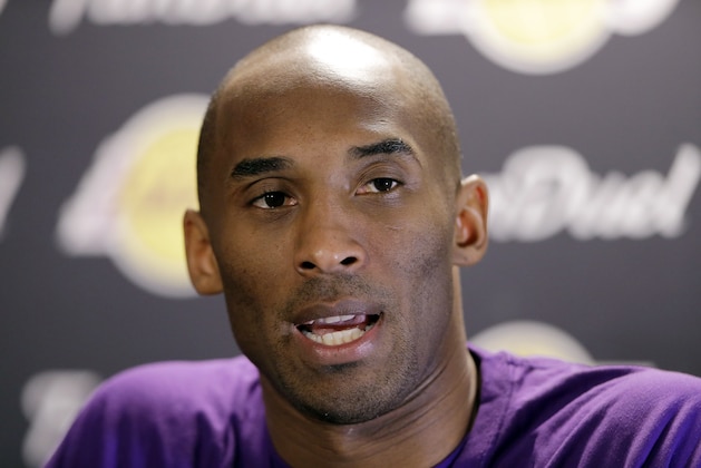 Los Angeles Lakers' Kobe Bryant speaks with members of the media ahead of a basketball game against the Philadelphia 76ers Tuesday, Dec. 1, 2015, in Philadelphia. (AP Photo/Matt Rourke)