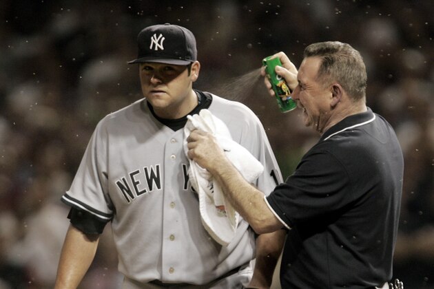 ** FILE ** New York Yankees trainer Gene Monahan sprays New York Yankees pitcher Joba Chamberlain with bug spray as swarms of small insects swarm in the eighth inning of a baseball playoff game Oct. 5, 2007, in Cleveland. A can of bug spray used in the Yankees' dugout when the tiny midges swarmed Cleveland's Jacobs Field will be among the items up for bid in a Major League Baseball auction of memorabilia from the 2007 postseason. (AP Photo/Amy Sancetta)