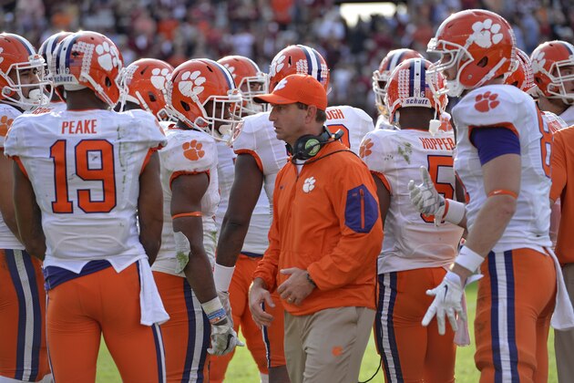 Clemson head coach Dabo Swinney huddles with his players during the second half of an NCAA college football game against South Carolina Saturday, Nov. 28, 2015, in Columbia, S.C. Clemson won 37-32. (AP Photo/Richard Shiro)