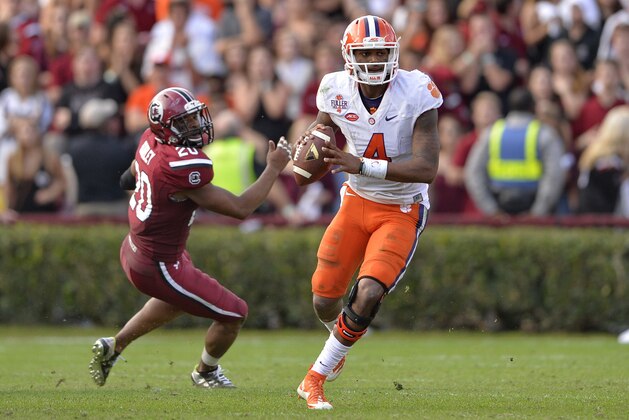 Clemson quarterback Deshaun Watson scrambles out of the pocket looking for a receiver during the second half of an NCAA college football game against South Carolina Saturday, Nov. 28, 2015, in Columbia, S.C. Clemson won 37-32. (AP Photo/Richard Shiro)