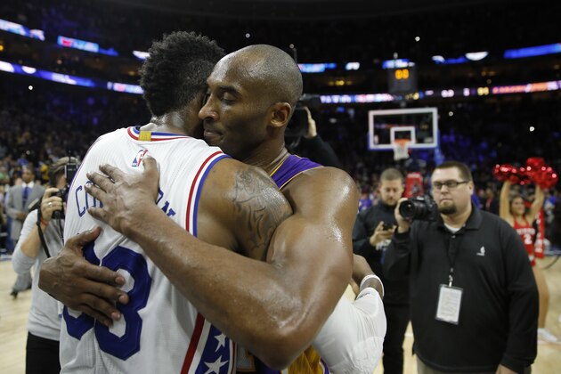 Los Angeles Lakers' Kobe Bryant, right, and Philadelphia 76ers' Robert Covington embrace after an NBA basketball game, Tuesday, Dec. 1, 2015, in Philadelphia. Philadelphia won 103-91. (AP Photo/Matt Slocum)