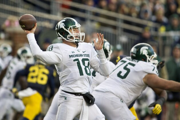 Michigan State quarterback Connor Cook (18) throws a pass in the third quarter of an NCAA college football game against Michigan in Ann Arbor, Mich., Saturday, Oct. 17, 2015. Michigan State won 27-23. (AP Photo/Tony Ding)
