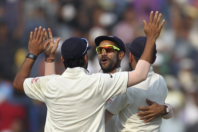 Indian cricketers, from left to right, Murali Vijay, Shikhar Dhawan and Virat Kohli  celebrate as India wins against South Africa on the third day of the third cricket test match between the two countries in Nagpur, India, Friday, Nov. 27, 2015. (AP Photo/Rafiq Maqbool)