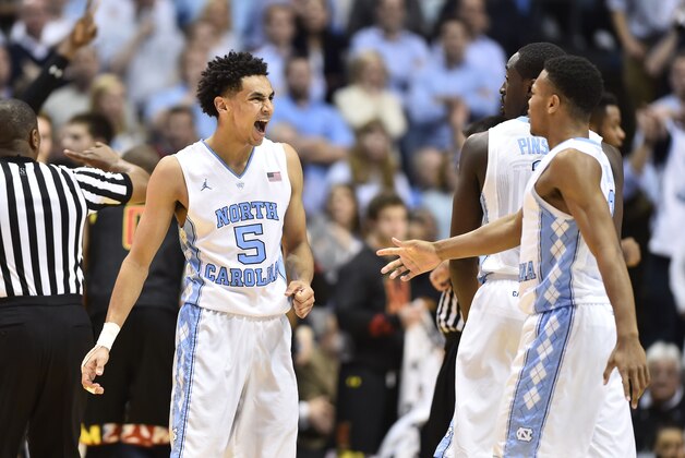 Dec 1, 2015; Chapel Hill, NC, USA; North Carolina Tar Heels guard Marcus Paige (5) reacts with forward Theo Pinson (1) and guard Nate Britt (0) in the second half. The Tar Heels defeated the Terrapins 89-81 at Dean E. Smith Center. Mandatory Credit: Bob Donnan-USA TODAY Sports