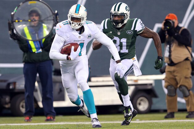 Miami Dolphins wide receiver DeVante Parker (11) runs with the ball against New York Jets corner back Antonio Cromartie (31) during an NFL game at MetLife Stadium in East Rutherford, N.J. on Sunday, Nov. 29, 2015. (AP Photo/Brad Penner)