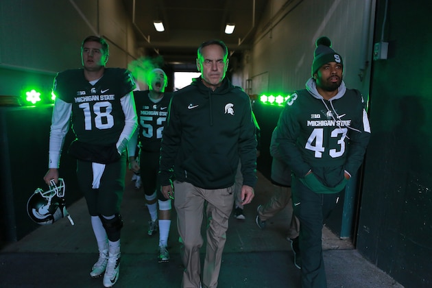 EAST LANSING, MI - NOVEMBER 28: Head coach Mark Dantonio of the Michigan State Spartans leads his team onto the field prior to a game against the Penn State Nittany Lions at Spartan Stadium on November 28, 2015 in East Lansing, Michigan. (Photo by Rey Del Rio/Getty Images)