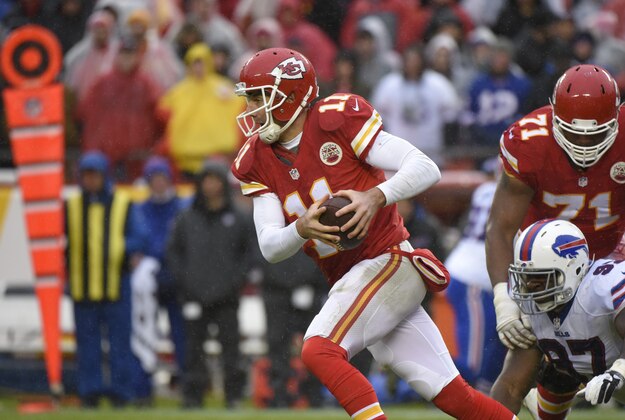 Kansas City Chiefs quarterback Alex Smith (11) runs past a tackle attempt by Buffalo Bills defensive tackle Corbin Bryant (97) during the second half of an NFL football game in Kansas City, Mo., Sunday, Nov. 29, 2015. (AP Photo/Ed Zurga)