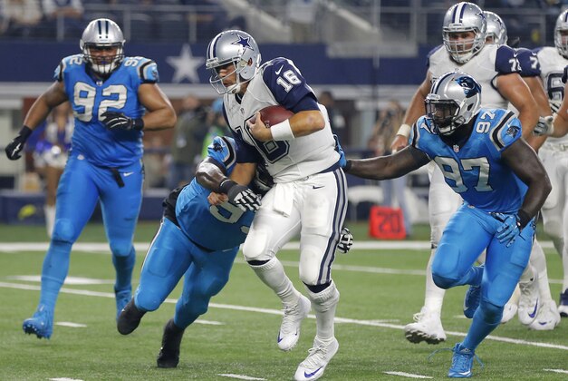 Dallas Cowboys quarterback Matt Cassel (16) is tackled by Carolina Panthers' Kyle Love (93) and Mario Addison (97) as Dwan Edwards (92) watches during the second half of an NFL football game Thursday, Nov. 26, 2015, in Arlington, Texas. (AP Photo/Brandon Wade)