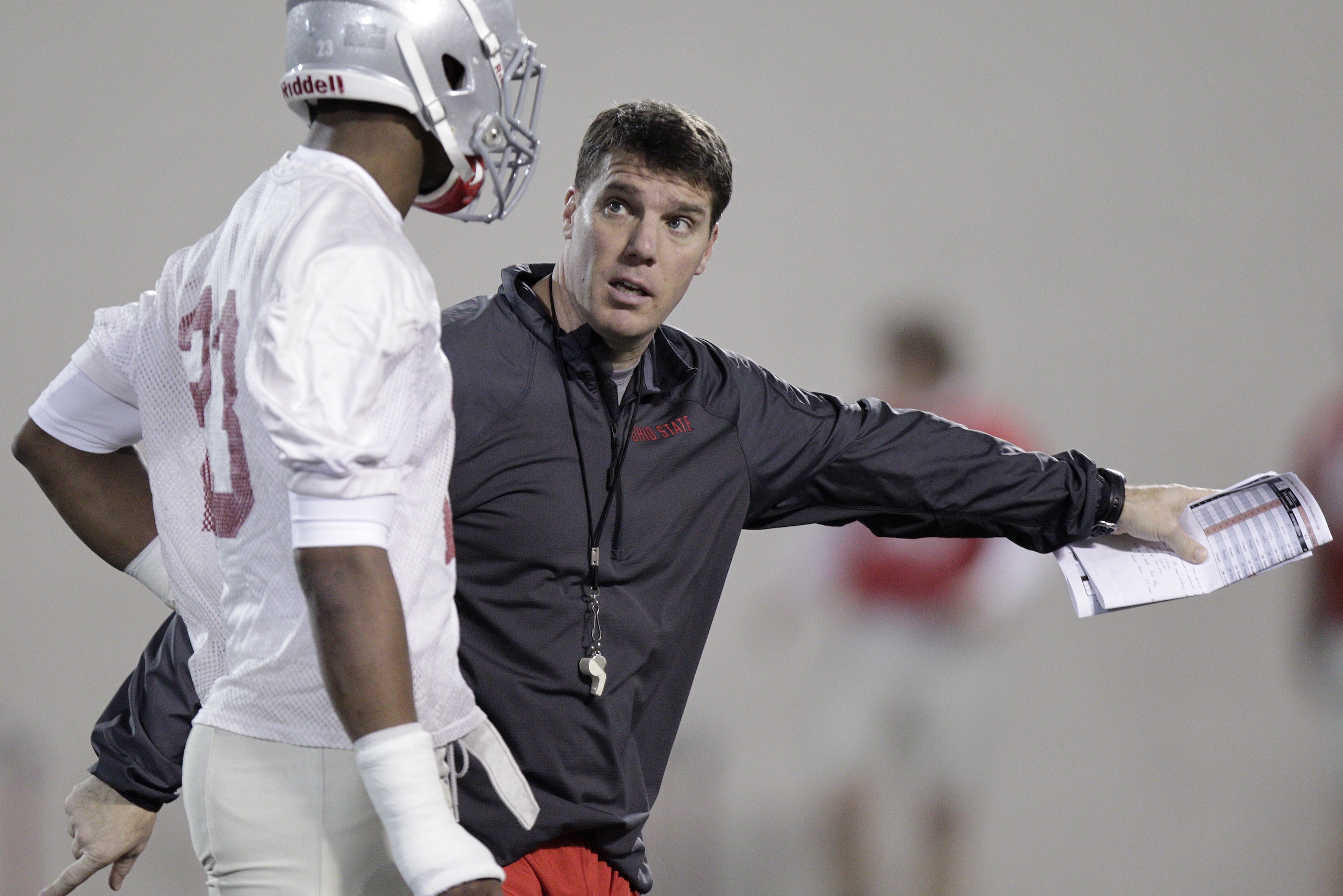 FILE - This March 4, 2014 file photo shows Ohio State's new co-defensive coordinator and safeties coach Chris Ash instructing defensive back Tyvis Powell during their Spring NCAA college football practice, in Columbus, Ohio. A lot of the early preseason publications and websites figure Ohio State should have one of the top 10 or 15 teams in the country. If the Buckeyes live up to that hype, it’ll likely be because of a lot of players who are unknown to even staunch fans. (AP Photo/Jay LaPrete, File)