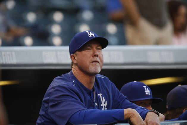 Los Angeles Dodgers batting coach Mark McGwire (25) looks on against he Colorado Rockies in the first inning of a baseball game Friday, Sept. 25, 2015, in Denver. (AP Photo/David Zalubowski)