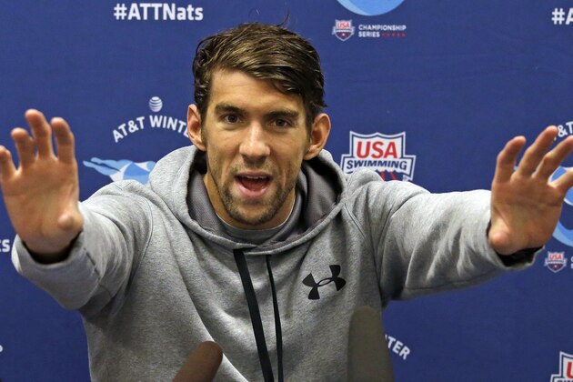 Michael Phelps gestures as he speaks with media members after practicing for the U.S. Winter Nationals swimming event Wednesday, Dec. 2, 2015, in Federal Way, Wash. Phelps will put a cap on his 2015 season at the event this week. It's his final opportunity to show just where his comeback is at before the Olympic year arrives. (AP Photo/Elaine Thompson)