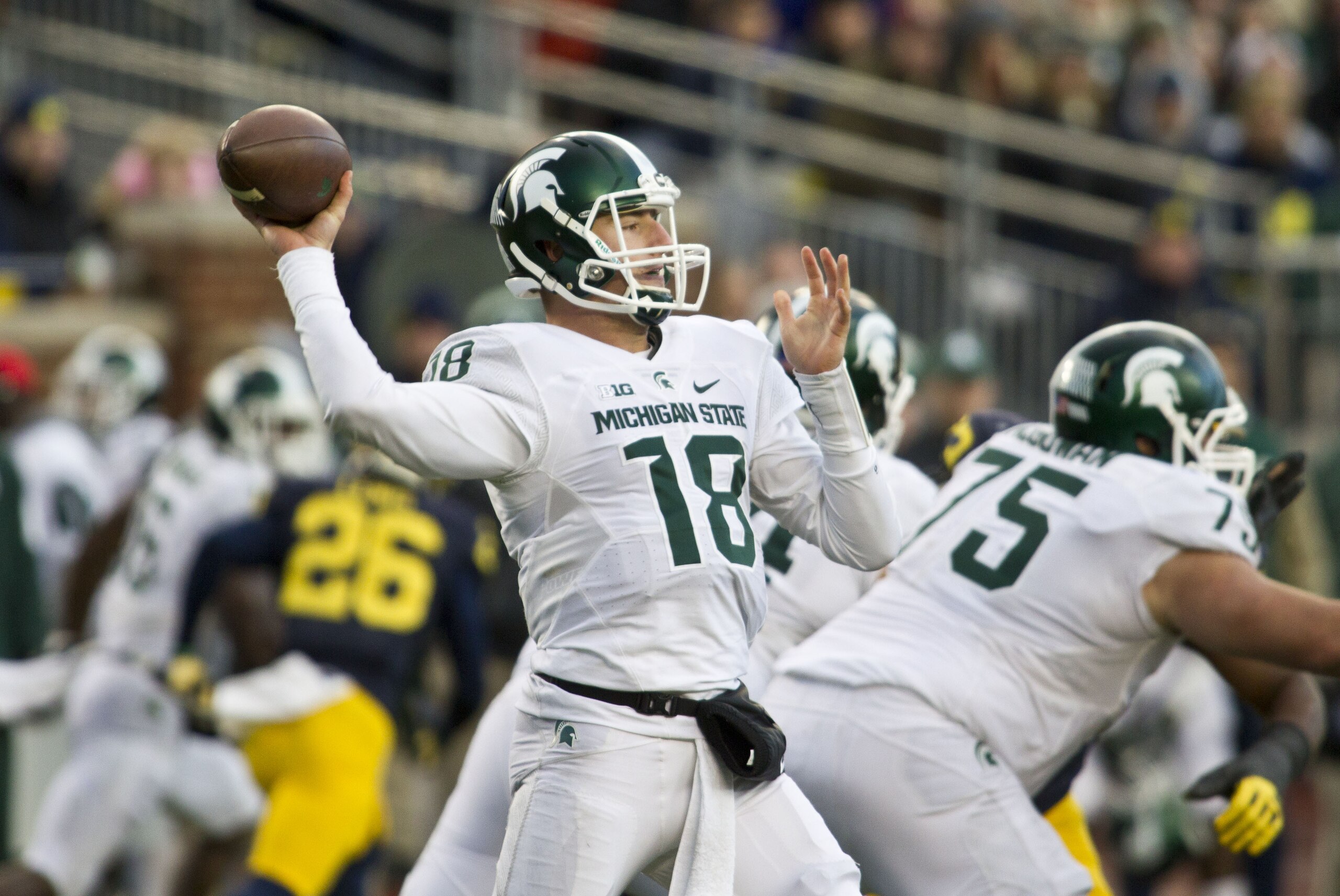 Michigan State quarterback Connor Cook (18) throws a pass in the third quarter of an NCAA college football game against Michigan in Ann Arbor, Mich., Saturday, Oct. 17, 2015. Michigan State won 27-23. (AP Photo/Tony Ding)