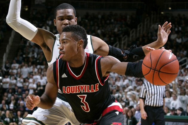 Louisville's Trey Lewis (3) drives against Michigan State's Alvin Ellis III during the first half of an NCAA college basketball game, Wednesday, Dec. 2, 2015, in East Lansing, Mich. (AP Photo/Al Goldis)