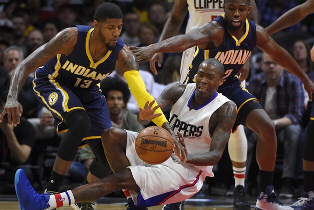 Los Angeles Clippers guard Jamal Crawford, center, loses control of the ball as Indiana Pacers forward Paul George, left, takes it and guard Rodney Stuckey watches during the first half of an NBA basketball game, Wednesday, Dec. 2, 2015, in Los Angeles. (AP Photo/Mark J. Terrill)