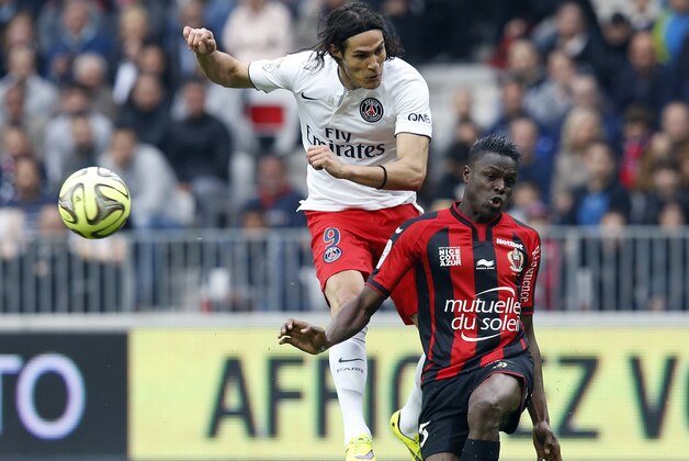 Paris Saint-Germain's Uruguayan forward Edinson Cavani (L) vies with Nice's French defender Romain Genevois (R) during the French L1 football match betweem Nice and Paris on April 18, 2015 at the 'Allianz Riviera' stadium in Nice, southeastern France. AFP PHOTO / VALERY HACHE        (Photo credit should read VALERY HACHE/AFP/Getty Images)