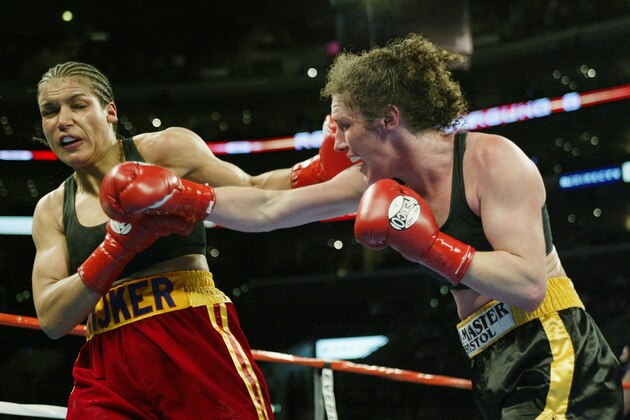 LOS ANGELES - JUNE 21: Jane Couch (right) hits Lucia Rijker during their women's light welterweight bout at the Staples Center on June 21, 2003 in Los Angeles, California.  Lucia Rijker (16-0) beat Jane Couch (19-5) by unanimous decision in eight rounds.  (Photo by Jed Jacobsohn/Getty Images)