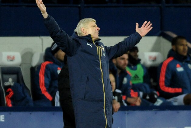 Arsenal manager Arsene Wenger throws out his arms during the English Premier League soccer match between West Bromwich Albion and Arsenal at the Hawthorns, West Bromwich, England, Saturday, Nov. 21, 2015. (AP Photo/Rui Vieira)