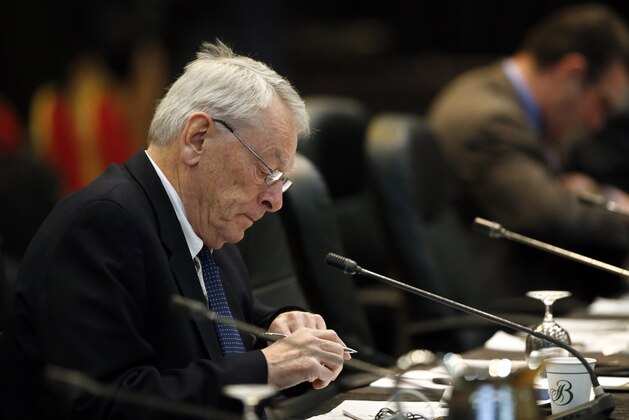 Dick Pound, the author of the report that detailed anti-doping corruption in Russia, prepares during a break in a meeting of the World Anti-Doping Agency (WADA), at the Broadmoor Hotel in Colorado Springs, Wednesday, Nov. 18, 2015. Leaders from the World Anti-Doping Agency met Wednesday to decide whether to ban Russia's anti-doping operation in the wake of the report about corruption in the country's track and anti-doping programs. (AP Photo/Brennan Linsley)