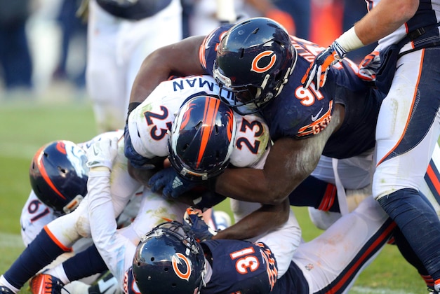 Nov 22, 2015; Chicago, IL, USA; Denver Broncos running back Ronnie Hillman (23) is tackled by Chicago Bears nose tackle Eddie Goldman (91) during the second half at Soldier Field. Denver won 17-15. Mandatory Credit: Dennis Wierzbicki-USA TODAY Sports