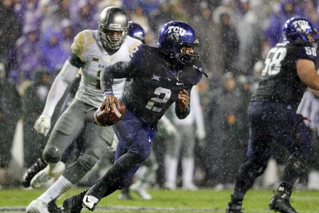 TCU quarterback Trevone Boykin runs out of the pocket under pressure from Baylor defensive end Shawn Oakman, rear, during the second half of an NCAA college football game, Friday, Nov. 27, 2015, in Fort Worth, Texas. TCU won 28-21 in double overtime. (AP Photo/Tony Gutierrez)