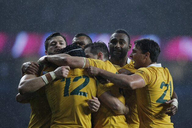 Australia's wing Adam Ashley-Cooper (L) and Australia's centre Tevita Kuridrani (2nd R) celebrate with teammates after winning a quarter final match of the 2015 Rugby World Cup between Australia and Scotland at Twickenham stadium, southwest London, on October 18, 2015. AFP PHOTO / ADRIAN DENNIS
RESTRICTED TO EDITORIAL USE, NO USE IN LIVE MATCH TRACKING SERVICES, TO BE USED AS NON-SEQUENTIAL STILLS (Photo credit should read ADRIAN DENNIS/AFP/Getty Images) Australia's wing Adam Ashley-Cooper (L) and Australia's centre Tevita Kuridrani (2nd R) celebrate with teammates after winning a quarter final match of the 2015 Rugby World Cup between Australia and Scotland at Twickenham stadium, southwest London, on October 18, 2015. AFP PHOTO / ADRIAN DENNIS
RESTRICTED TO EDITORIAL USE, NO USE IN LIVE MATCH TRACKING SERVICES, TO BE USED AS NON-SEQUENTIAL STILLS (Photo credit should read ADRIAN DENNIS/AFP/Getty Images)