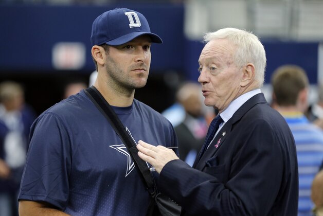 Dallas Cowboys owner Jerry Jones, right, talks with injured quarterback Tony Romo, left, before an NFL football game against the New England Patriots, Sunday, Oct. 11, 2015, in Arlington, Texas. (AP Photo/Brandon Wade)