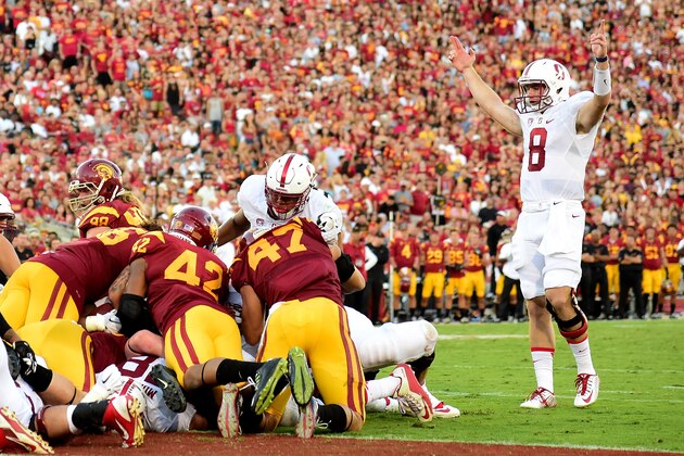 LOS ANGELES, CA - SEPTEMBER 19:  Kevin Hogan #8 of the Stanford Cardinal raises his arms in celebration of a touchdown by Remound Wright #22 at Los Angeles Coliseum on September 19, 2015 in Los Angeles, California.  The play required video review to confirm the touchdown.  (Photo by Harry How/Getty Images)