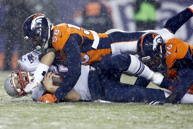 New England Patriots quarterback Tom Brady (12) is hit late by Denver Broncos outside linebacker Von Miller (58) for a penalty after being sacked by Denver Broncos defensive end Vance Walker (96) during the second half of an NFL football game, Sunday, Nov. 29, 2015, in Denver. (AP Photo/Joe Mahoney)