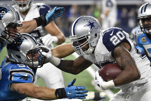 Dallas Cowboys' Darren McFadden (20) runs the ball as Carolina Panthers middle linebacker A.J. Klein attempts the stop during the first half of an NFL football game Thursday, Nov. 26, 2015, in Arlington, Texas. (AP Photo/Michael Ainsworth)