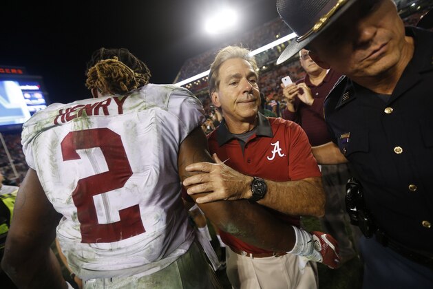 Alabama head coach Nick Saban embraces Alabama running back Derrick Henry (2) at the end of an NCAA college football game against Auburn, Saturday, Nov. 28, 2015, in Auburn, Ala. Alabama won 29-13. (AP Photo/Gerald Herbert)