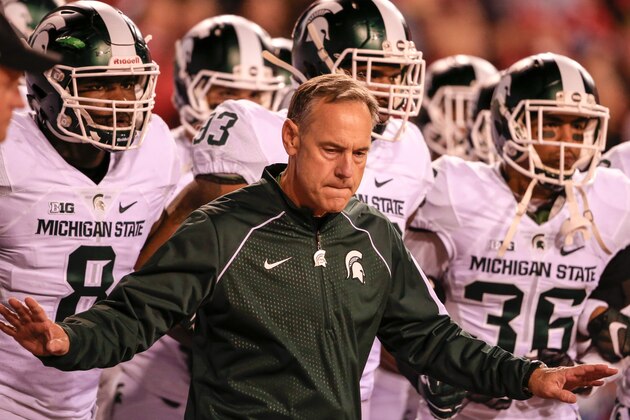 Michigan State head coach Mark Dantonio holds back his players from taking the field before an NCAA college football game against Nebraska in Lincoln, Neb., Saturday, Nov. 7, 2015. Nebraska won 39-38. (AP Photo/Nati Harnik)