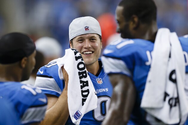 Detroit Lions quarterback Matthew Stafford, center, on the sideline with wide receiver Calvin Johnson, right, and wide receiver Golden Tate, left, against the New York Giants during an NFL football game at Ford Field in Detroit, Monday, Sept. 8, 2014. (AP Photo/Rick Osentoski)