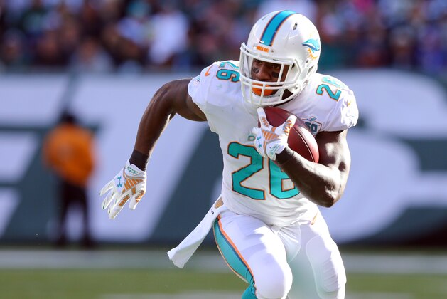 Miami Dolphins running back Lamar Miller (26) runs with the ball against the New York Jets during an NFL game at MetLife Stadium in East Rutherford, N.J. on Sunday, Nov. 29, 2015. (AP Photo/Brad Penner)