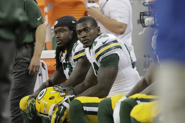 Green Bay Packers running back Eddie Lacy, background, and running back James Starks are seen on the bench during the second half of an NFL football game against the Detroit Lions in Detroit, Sunday, Sept. 21, 2014. (AP Photo/Duane Burleson)