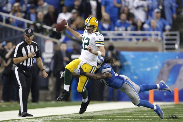 Dec 3, 2015; Detroit, MI, USA; Detroit Lions outside linebacker Josh Bynes (57) forces Green Bay Packers quarterback Aaron Rodgers (12) out of bounds during the second quarter at Ford Field. Mandatory Credit: Raj Mehta-USA TODAY Sports