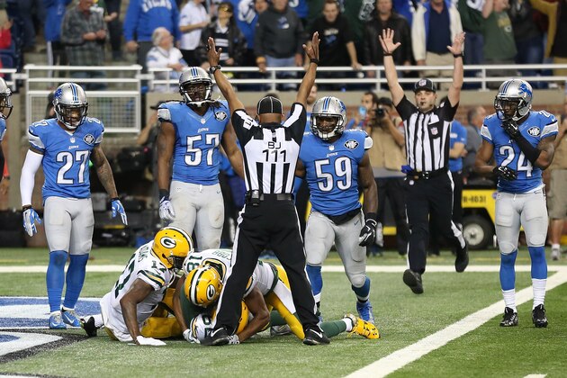 DETROIT MI - DECEMBER 3: The back judge Terrence Miles #111 signals the touchdown good after Richard Rodgers #82 of the Green Bay Packers catches a 61 yard pass to win the game 27-23 over the Detroit Lions on December 3 2015 at Ford Field in Detroit, Michigan. (Photo by Leon Halip/Getty Images)
