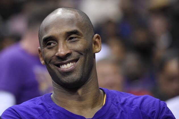 Los Angeles Lakers forward Kobe Bryant smiles as he looks on from the bench during the second half of an NBA basketball game against the Washington Wizards, Wednesday, Dec. 2, 2015, in Washington. The Lakers won 108-104. (AP Photo/Nick Wass)