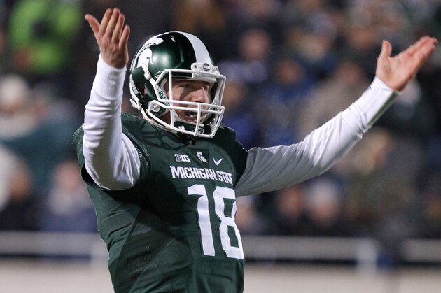 Michigan State quarterback Connor Cook encourages the crowd during the fourth quarter of an NCAA college football game against Penn State, Saturday, Nov. 28, 2015, in East Lansing, Mich. Michigan State won 55-16. (AP Photo/Al Goldis)