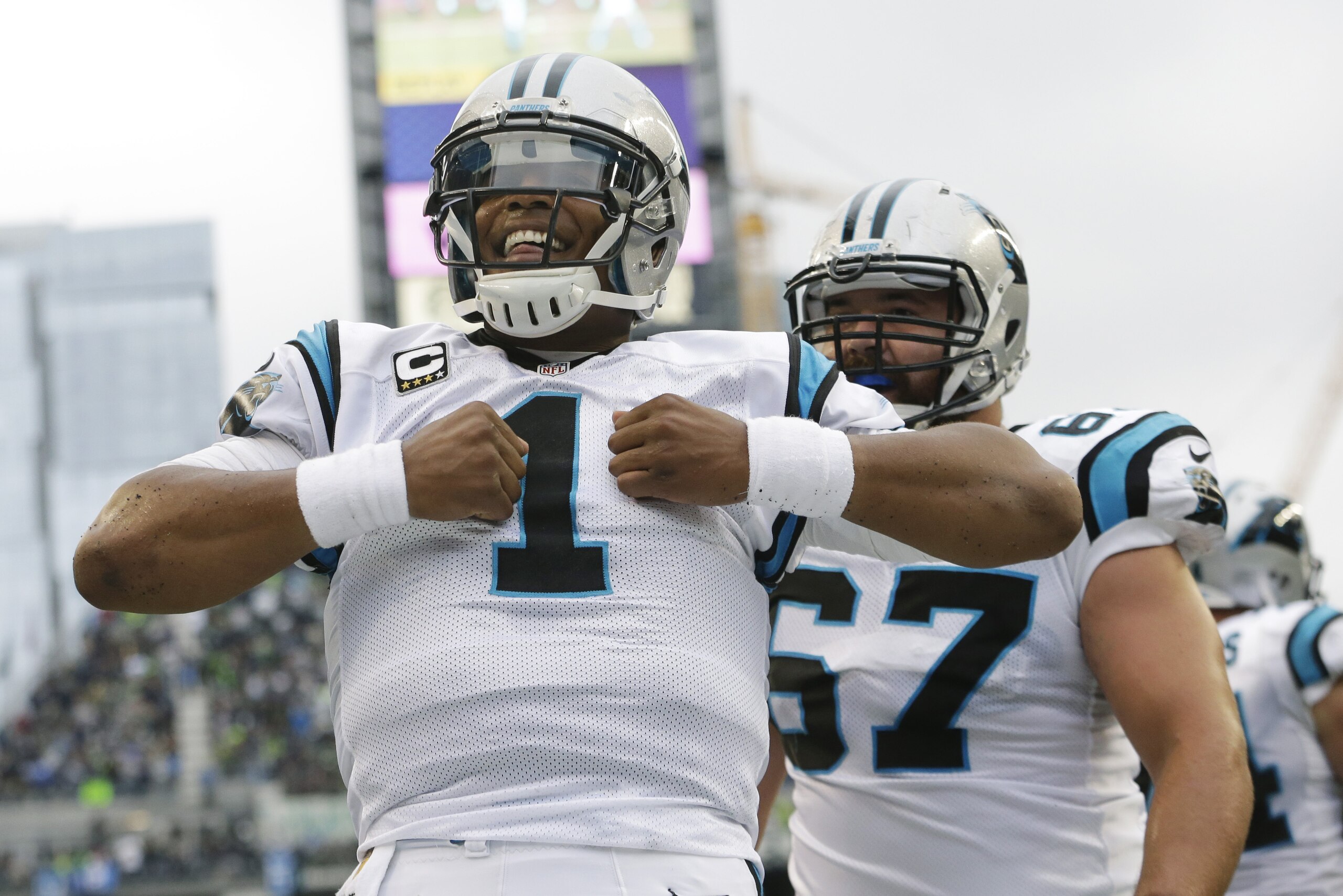 Carolina Panthers quarterback Cam Newton reacts after he rushed for a touchdown in the first half of an NFL football game against the Seattle Seahawks, Sunday, Oct. 18, 2015, in Seattle. (AP Photo/Elaine Thompson)