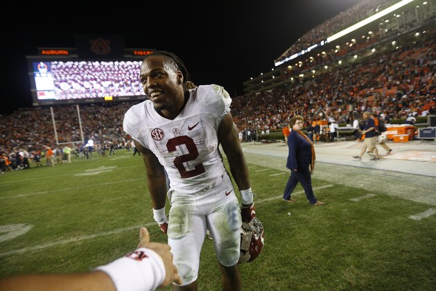 Alabama running back Derrick Henry (2) smiles at  Auburn defensive back Tray Matthews (28) during the end of an NCAA college football game, Saturday, Nov. 28, 2015, in Auburn, Ala. Alabama won 29-13. (AP Photo/Gerald Herbert)